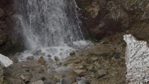 Mountain waterfall flowing through rocky canyon, close up view. Slowmotion. Stock Footage 333903699