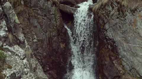 Mountain waterfall flowing through rocky canyon, close view Видео 333903720