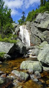 Mountain waterfall on the rocks. Stock Photos