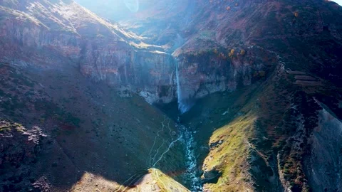 Mountain Waterfall with Sun Rays and Morning Mist Stock Footage 325763658
