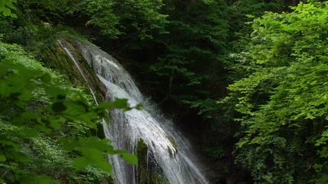 Mountain waterfall surrounded by green forest Stock Footage 144621535