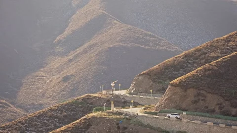 Mountain Winding Road through Yellow Grass with Moving Cars 스톡 동영상 326426683