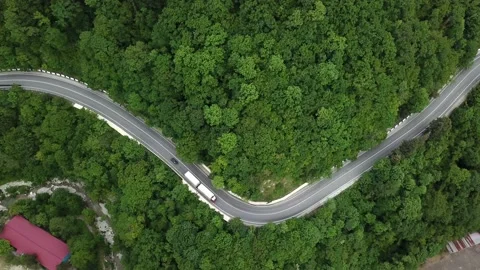 Mountain winding zig zag road. Top aerial view: cars driving on road from above. Stock Footage 132209853