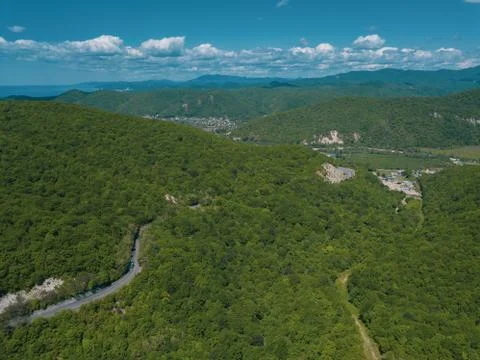 Mountain winding zig zag road. Top aerial view: cars driving on road from above. Fotos Stock