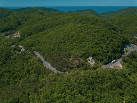 Mountain winding zig zag road. Top aerial view: cars driving on road from above. Fotos Stock