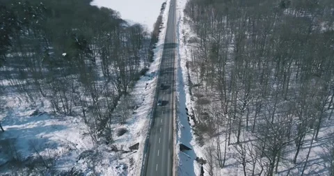 The mountain winter forest with road covered with snow Stock Footage 246866917