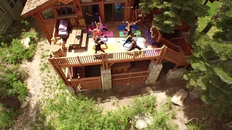 Mountain Yoga Session on Cabin Deck Aerial 4K Stock Footage 54985210