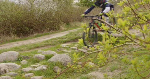 Mountainbiker going over stone trail overcast day Stock Footage 189320741