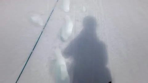 Mountaineer abseiling down a snowy mountain slope Stock Footage 335105256