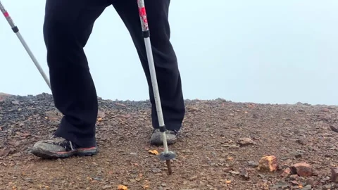 Mountaineer ascending in low angle over loose rocky ground Stock Footage 343771328