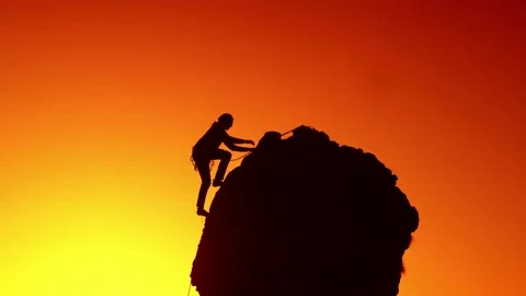 A mountaineer climbs Stock Footage 149420380