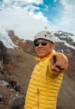 Mountaineer looking at the camera and in the background the cayambe volcano Stock Photos