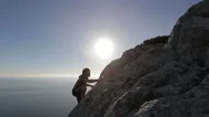 Mountaineer Reaches The Summit. Man Climbs A Mountain An Celebrates The Stock Footage