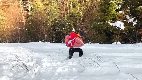 Mountaineer testing an avalanche protection backpack Stock Footage 85836069