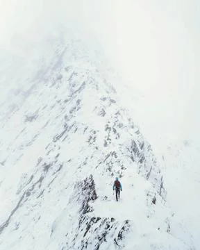 Mountaineer using an ice axe to climb Forcan Ridge in Glen Shiel, Scotland Stock Photos