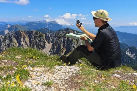Mountaineer using map and compass Stock Photos