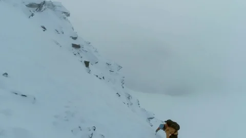 Mountaineer Using a Pick to Climb a Snowy Mountain Stock Footage 84736592
