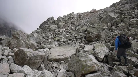 Mountaineer walking through stone field Stock-Footage 43249104