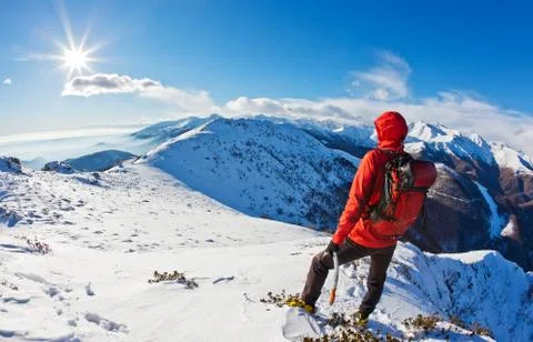 Mountaineer while observing a mountain panorama. Stock Photos