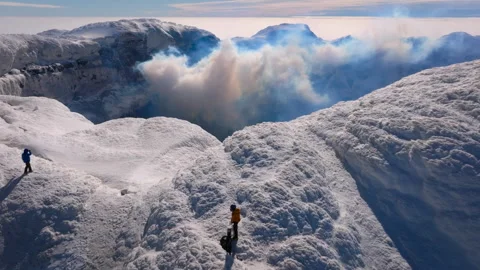 Mountaineers exploring an active volcano crater edge Stock Footage 335498235