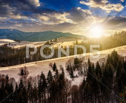 Mountainous area on winter at sunset Stock Photos