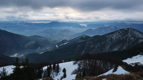Mountainous hilly landscape in winter, Cloudy windy weather, fast movement of Video stock 261555244