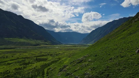 Mountainous landscape with fields and clouds Stock Footage 247392477