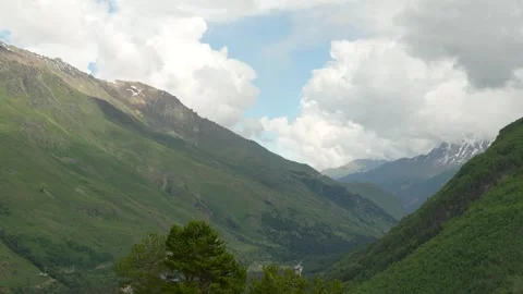 The mountainous landscape mixed terrain, forest, rocks, snow Stock Footage 342713917