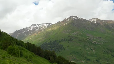The mountainous landscape mixed terrain, forest, rocks, snow Stock Footage 342713927