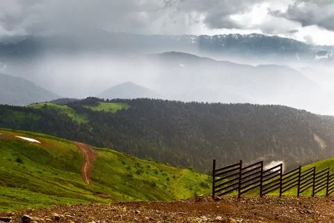 The mountainous landscape of the slopes covered by forest. Stock Photos