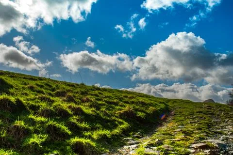 The mountainous path in the sky is high in the background. Stock Photos