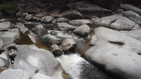 Mountainous river makes foam running among huge sharp rocks Stock Footage 162898768