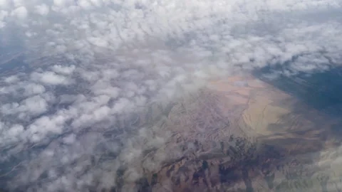 Mountainous terrain through clouds Видео 240265604