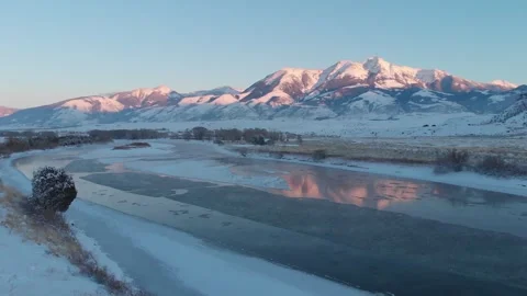 Mountains with alpenglow reflecting in river Stock Footage 310527257