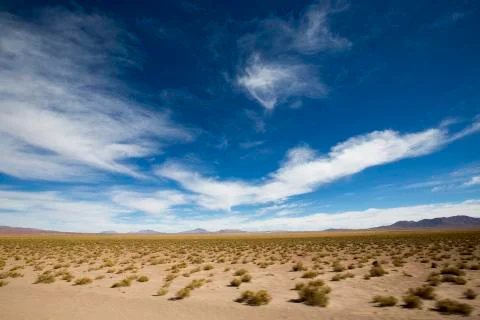 Mountains and arid landscape with blue sky in Bolivia Stock Photos