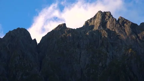 Mountains and cliffs in the sun and blue sky in New Zealand Milford Sound Stock Footage 132062866