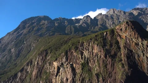 Mountains and cliffs in the sun rays and sky with clouds Stock-Footage 132062555