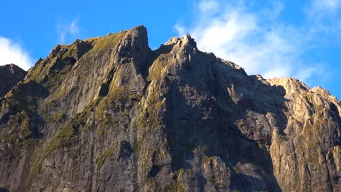Mountains and cliffs in the sun rays and sky with clouds Stock Footage 132062771