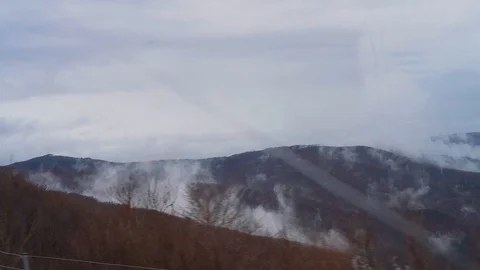 Mountains and clouds outside the bus window Stock Footage 124223097
