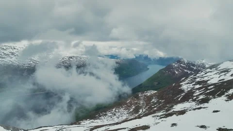 Mountains and Fiord in the clouds over Olden, Innvikfjorden, Norway Stock Footage 242594836