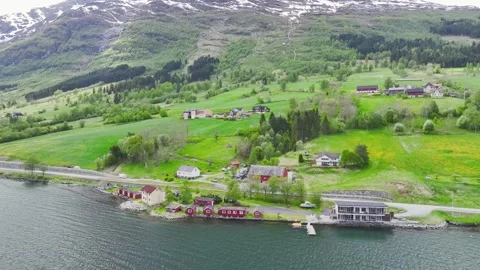 Mountains and Fiord in the clouds over Village, Olden, Innvikfjorden, Norway Stock Footage 242634179