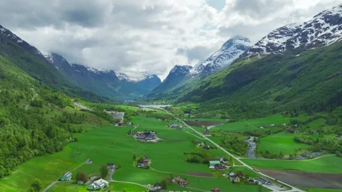 Mountains and Fiord in the clouds over Village, Olden, Innvikfjorden, Norway Stock Footage 242695149