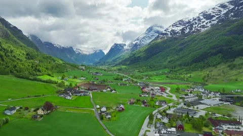 Mountains and Fiord in the clouds over Village, Olden, Innvikfjorden, Norway Stock Footage 242695169