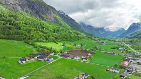 Mountains and Fiord in the clouds over Village, Olden, Innvikfjorden, Norway Stock Footage 242695194