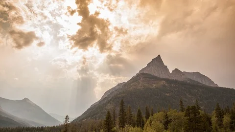 Mountains and Forest Timelapse, Overcast Clouds Sunset, Waterton Lakes, Alberta Stock Footage 103885305