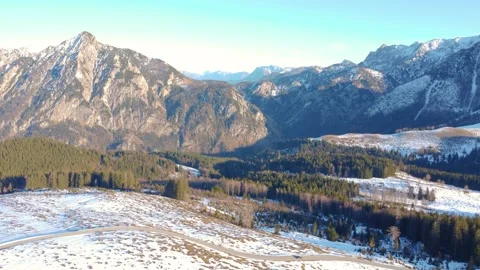 Mountains and forest in winter: a view of a mountain valley with snow-covered fi Stock Footage 303638541
