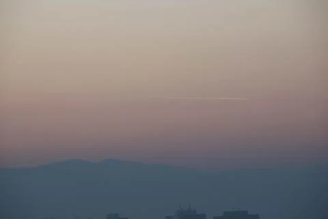 Mountains and gradient sky during sunset. Stock Photos