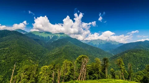 Mountains and green trees on foreground time lapse Stock Footage 82187651