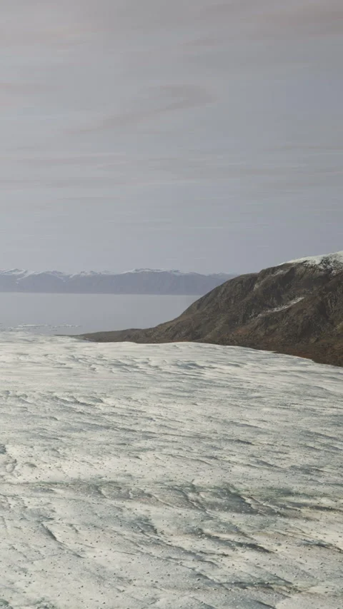 Mountains and ice flow with clouds in the sky over a vast ocean landscape Stock Footage 337960582
