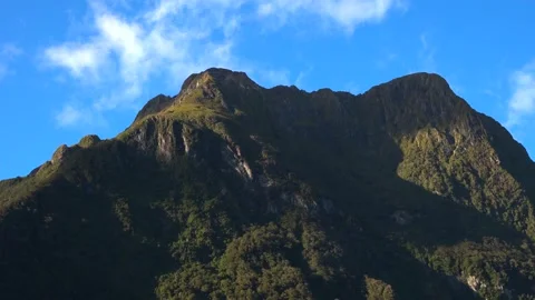 Mountains and rocks in the sun rays with green trees Stock Footage 132062730